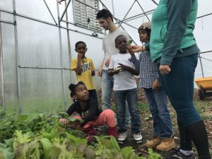 Club Grub Kids play in the hoophouse