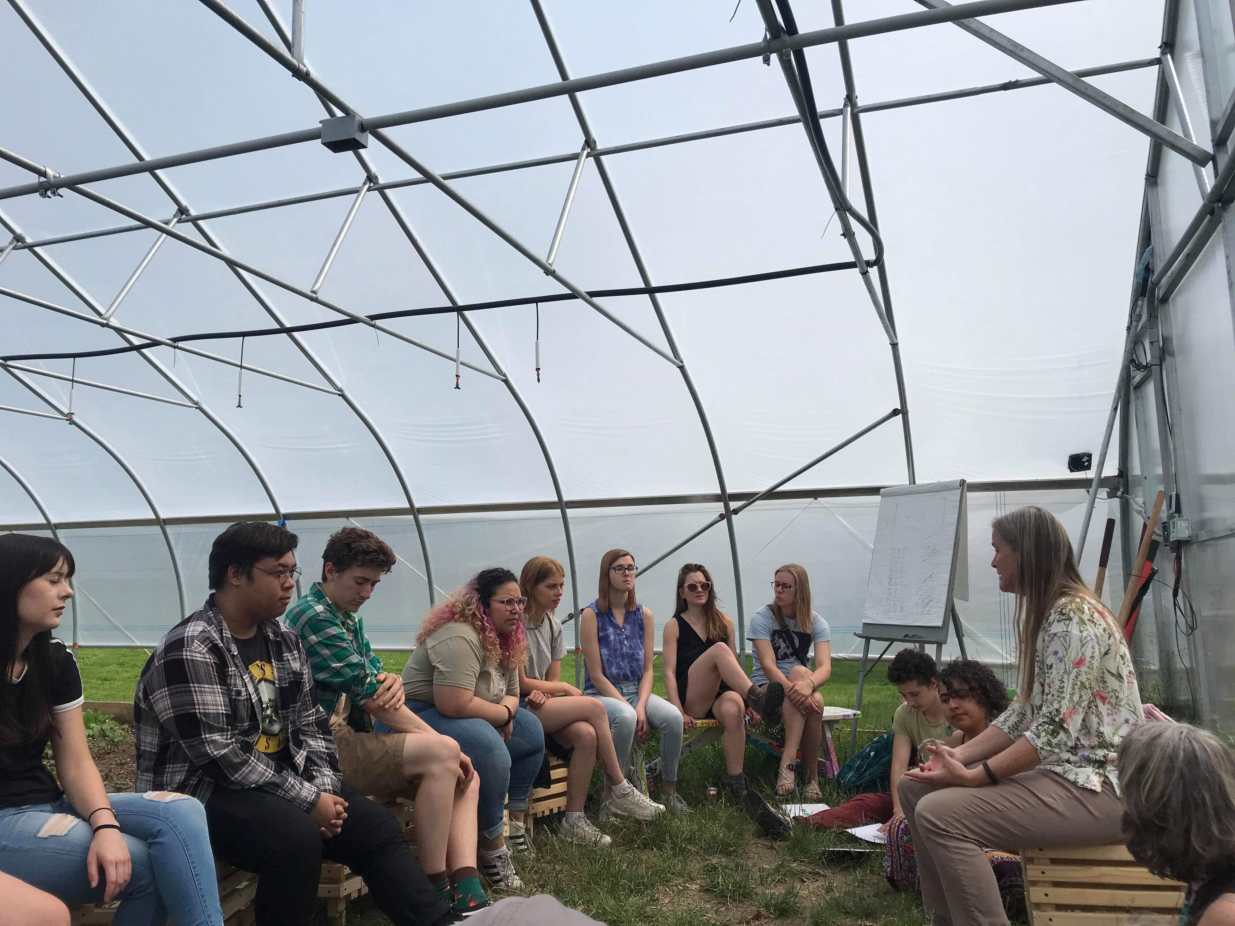 Dr. Binney Girdler leading a discussion in the hoophouse about ecology of gardens